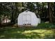 Backyard shed with white double doors and a lattice base in a shady, grassy area at 1636 Springwinds Dr, Rock Hill, SC 29730