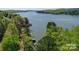 Beautiful aerial view of waterfront property surrounded by lush greenery and tranquil waters at 177 Mountain View Ln, Troy, NC 27371
