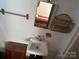 Small bathroom featuring a white sink, mirror, and wicker shelves at 177 Mountain View Ln, Troy, NC 27371