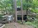 View of a boat dock with covered slip, set among mature trees and foliage at 177 Mountain View Ln, Troy, NC 27371