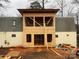 Exterior of a house undergoing construction with a new addition featuring exposed framing and unfinished siding at 177 Mountain View Ln, Troy, NC 27371