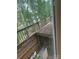 Exterior deck with views of the surrounding trees and a glimpse of the lake at 177 Mountain View Ln, Troy, NC 27371