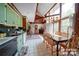 Open dining area features a wooden table and chairs, with views of the living room and spiral staircase, creating a cohesive design at 177 Mountain View Ln, Troy, NC 27371