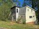 View of the exterior featuring a new addition with large windows and siding that complements the original structure at 177 Mountain View Ln, Troy, NC 27371