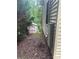 Exterior side view of a home with vinyl siding and a small storage shed surrounded by trees and foliage at 177 Mountain View Ln, Troy, NC 27371