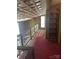 Hallway displaying exposed ceiling with a built-in bookshelf against red carpeting at 177 Mountain View Ln, Troy, NC 27371