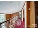 Hallway overlooking a room and with wood paneling and white trim at 177 Mountain View Ln, Troy, NC 27371