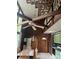 Kitchen awaiting renovation with exposed ceiling, wood paneling, and adjacent dining area at 177 Mountain View Ln, Troy, NC 27371