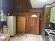 Kitchen awaiting renovation with wood paneling, a dated refrigerator, and tiled floors at 177 Mountain View Ln, Troy, NC 27371