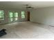 Open-concept living room with sliding glass doors and windows to a backyard view at 177 Mountain View Ln, Troy, NC 27371