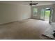 Bright living room with a ceiling fan, ample space, and a door leading to the outside at 177 Mountain View Ln, Troy, NC 27371