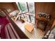 Open-concept living space featuring a dining area, exposed beams, and a wall of windows offering stunning views of the surrounding nature at 177 Mountain View Ln, Troy, NC 27371