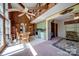 Bright living area featuring a kitchen, dining space, and cozy sitting area with a spiral staircase, creating an open and airy feel at 177 Mountain View Ln, Troy, NC 27371