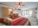 Cozy main bedroom featuring a fireplace, ensuite, and sliding glass doors to the outside deck at 177 Mountain View Ln, Troy, NC 27371