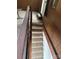 Interior staircase with carpeted steps and wooden railings providing access to the different levels of the home at 177 Mountain View Ln, Troy, NC 27371