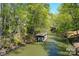 Waterfront property with a boat dock along the canal, nestled among green trees at 177 Mountain View Ln, Troy, NC 27371