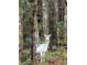 A white-spotted deer stands among the trees in the forest at 177 Mountain View Ln, Troy, NC 27371