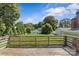 Fenced backyard with a large grass-covered area, surrounded by mature trees at 2000 Townsend Ave, Charlotte, NC 28205