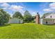 Lush backyard featuring a detached garage and privacy trees at 2000 Townsend Ave, Charlotte, NC 28205