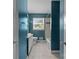 Hall bathroom with white sink and tub, tile surround, window and blue walls at 2000 Townsend Ave, Charlotte, NC 28205