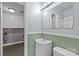 Bathroom with a vanity, toilet, shower and an open doorway to the laundry room at 2000 Townsend Ave, Charlotte, NC 28205