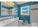Bathroom with white sink, commode, and tub shower with blue walls at 2000 Townsend Ave, Charlotte, NC 28205