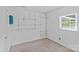 Bright bedroom featuring white walls, carpet flooring, and built-in storage shelves at 2000 Townsend Ave, Charlotte, NC 28205