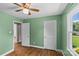 Bedroom with hardwood floors, white trim, a window, a closet and olive green walls at 2000 Townsend Ave, Charlotte, NC 28205