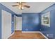 Cozy bedroom with hardwood floors, white trim, a window, and dark blue walls at 2000 Townsend Ave, Charlotte, NC 28205