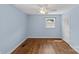 Light blue bedroom offers hardwood flooring, ceiling fan, and neutral trim at 2000 Townsend Ave, Charlotte, NC 28205