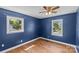 Bedroom with hardwood floors, two windows, and dark blue walls at 2000 Townsend Ave, Charlotte, NC 28205