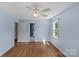 Bedroom featuring hardwood floors, a ceiling fan, a window, and a door to the bathroom at 2000 Townsend Ave, Charlotte, NC 28205