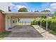 Covered carport beside the house with a view of the detached garage at 2000 Townsend Ave, Charlotte, NC 28205