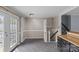Bright dining room with gray tile flooring, french doors, stairs to the basement and a pass through to the kitchen at 2000 Townsend Ave, Charlotte, NC 28205
