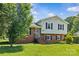 Classic home with a brick and siding exterior, complemented by a well-maintained front yard and mature tree at 2000 Townsend Ave, Charlotte, NC 28205