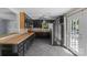Well-lit kitchen with gray tiled floor, sleek black cabinetry, tan countertops, and stainless steel appliances at 2000 Townsend Ave, Charlotte, NC 28205