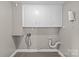 Bright utility room with ample cabinet storage and connections for washer and dryer at 2000 Townsend Ave, Charlotte, NC 28205