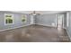 Open-concept living room with neutral paint, modern ceiling fan, and ample natural light at 2000 Townsend Ave, Charlotte, NC 28205