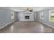 Living room with painted brick fireplace with a dark hearth and mantle at 2000 Townsend Ave, Charlotte, NC 28205