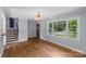 Spacious room with hardwood floors, a large window, and stairwell, offering a seamless flow and ample natural light at 2000 Townsend Ave, Charlotte, NC 28205