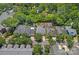 An aerial view of a residential neighborhood with mature trees and well-maintained homes at 202 Caldwell Ln, Davidson, NC 28036