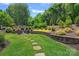 Well-manicured backyard with a stone seating area, perfect for entertaining at 202 Caldwell Ln, Davidson, NC 28036