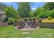 Cozy backyard retreat featuring a brick-paved seating area with comfortable chairs at 202 Caldwell Ln, Davidson, NC 28036