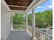 Charming balcony with white columns, offering a serene view of the lush neighborhood at 202 Caldwell Ln, Davidson, NC 28036