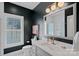 Modern bathroom with a stylish vanity, sleek fixtures, and a well-lit mirror at 202 Caldwell Ln, Davidson, NC 28036