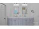 Elegant bathroom with double vanity, granite countertops, and modern fixtures at 202 Caldwell Ln, Davidson, NC 28036