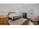 Serene bedroom featuring a comfortable bed, hardwood floors, and natural light at 202 Caldwell Ln, Davidson, NC 28036