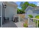 Inviting deck with a grill, seating, and steps leading to a landscaped backyard, ideal for outdoor entertaining at 202 Caldwell Ln, Davidson, NC 28036