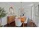 Elegant dining room with wooden table, white chairs, chandelier, and decorative wallpaper at 202 Caldwell Ln, Davidson, NC 28036