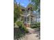 Elegant home featuring double porches, complemented by lush landscaping, creating a welcoming and picturesque facade at 202 Caldwell Ln, Davidson, NC 28036